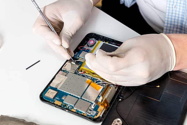 iPad repair — technician replacing a cracked tablet screen
