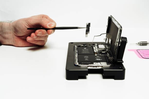 iPhone repair technician replacing a broken phone screen